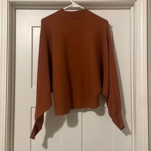 Size large, brand is Willow and Root, it’s an orange rusty color